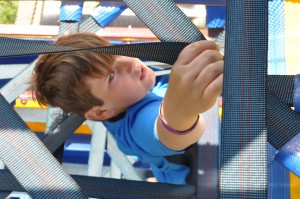 Boy climbing through spider mountain